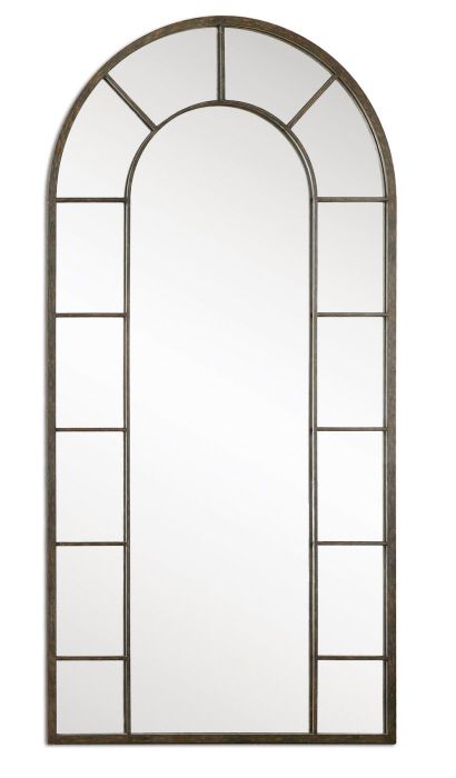 a tall arched mirror sitting on top of a white wall