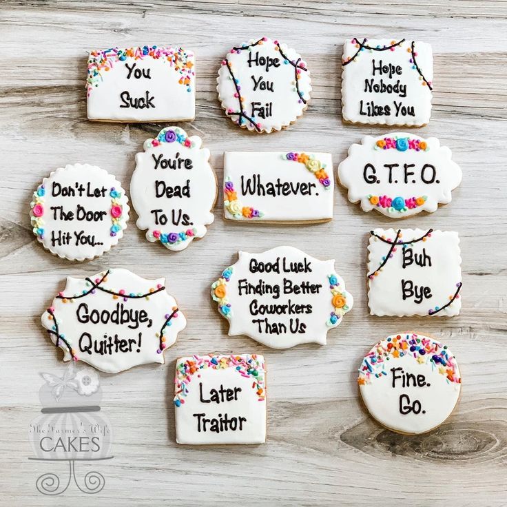 decorated cookies with different sayings on them sitting on a table next to each other