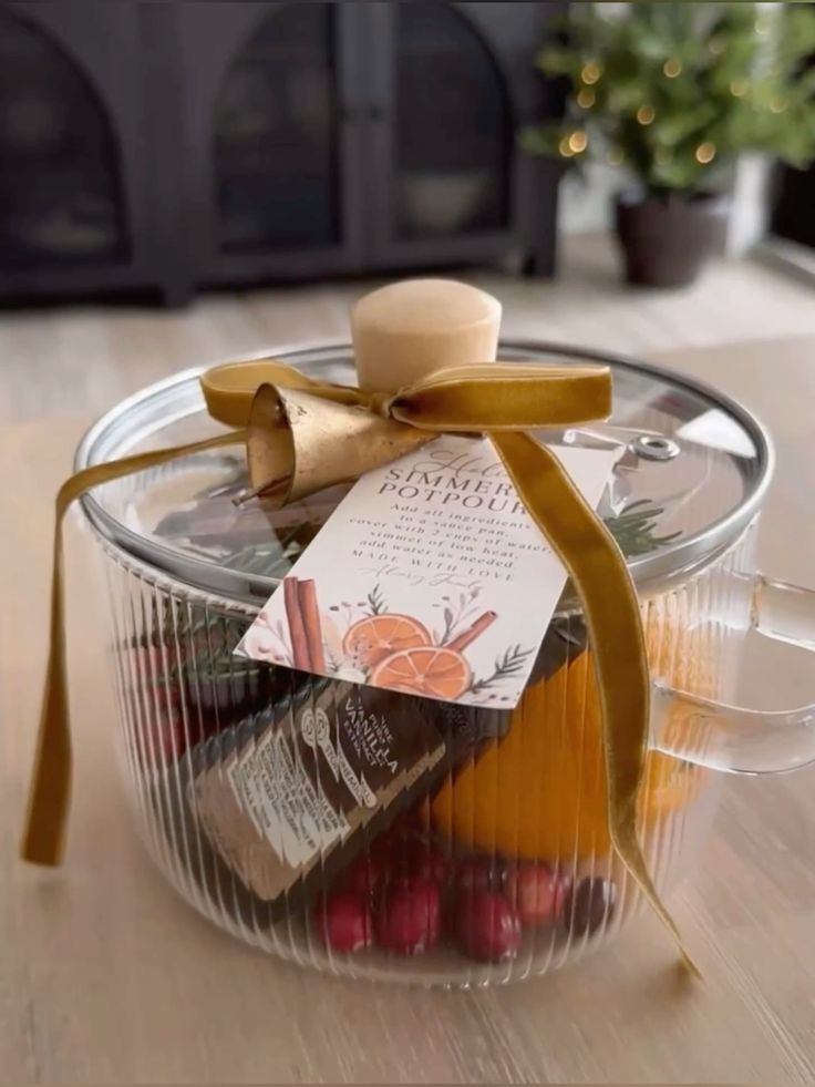 a glass container filled with assorted candies on top of a wooden table