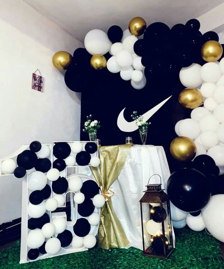 black and white balloons are on display in the room