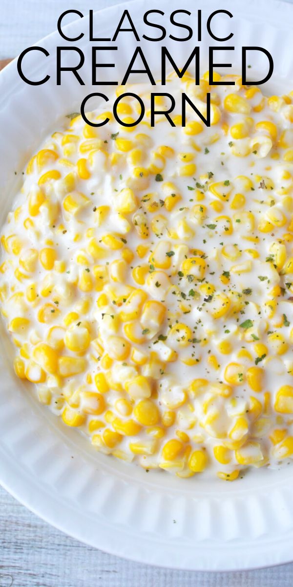 a white plate topped with corn covered in cream