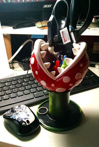 a desk with a computer keyboard, mouse and some office supplies on top of it