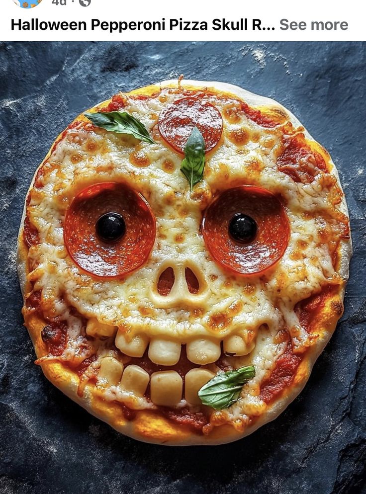 a pizza that has been decorated to look like a skull with pepperoni on it