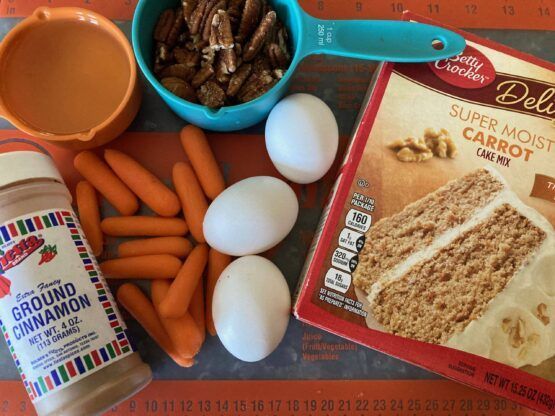 ingredients for carrot cake laid out on a cutting board