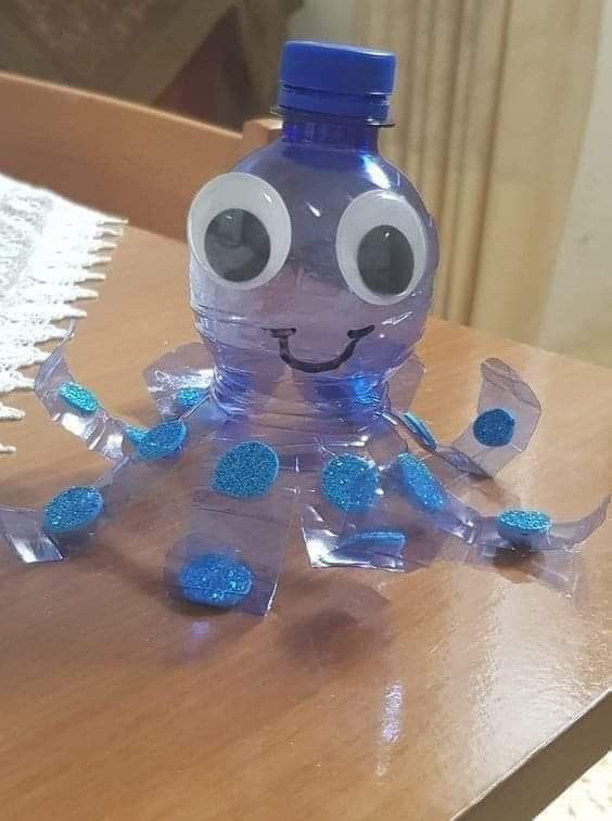 a plastic water bottle sitting on top of a wooden table