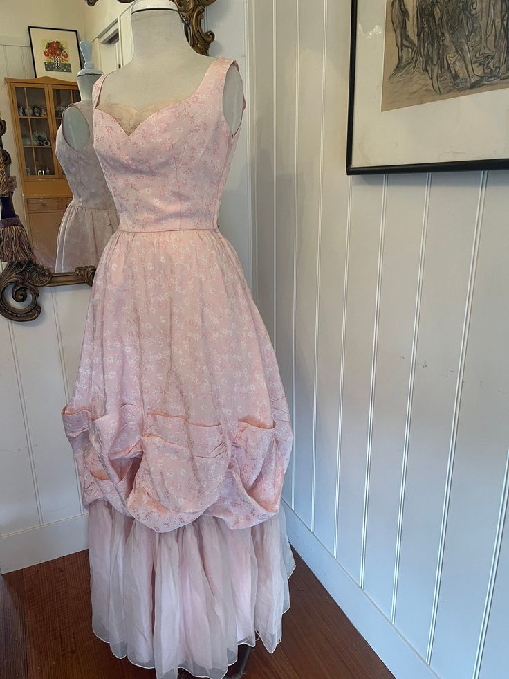 a pink dress on display in a room