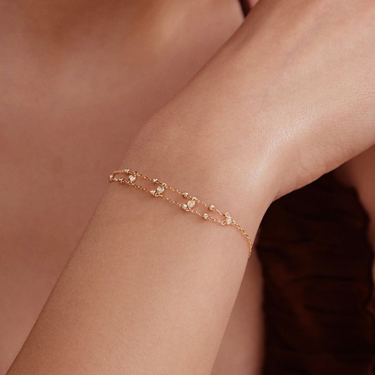 1- D E S C R I P T I O N Explore the timeless elegance of our Diamond Bead Station Bracelet, meticulously crafted in 14K solid gold. This bezel beaded double chain bracelet is a perfect blend of sophistication and sparkle, making it an ideal gift for her. With its exquisite design, this dainty 14k gold diamond jewelry piece is a must-have for every woman's collection, promising durability and lasting shine. 2- P R O D U C T ∙  F E A T U R E S * Gold Material: 14K solid gold * Gold Color Options: Delicate Beaded Bracelet For Anniversary, Delicate Gold Diamond Bracelet With Bezel Setting, Rose Gold Bracelet With Satellite Chain, Elegant Rose Gold Bracelets With Satellite Chain, Gold Faceted Bracelets, Elegant Bracelet With Satellite Chain As Gift, Elegant 14k Gold Chain Bracelet With Bezel Setting, Delicate Gold Bracelets With Bezel Setting, Elegant Satellite Chain Bracelet As Gift