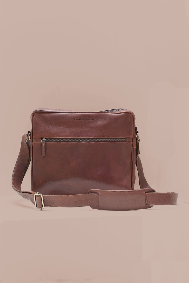 Carry your laptop in style & protection with our Leather Laptop Satchel in gorgeous brown leather. This sleek & durable satchel is specifically designed to fit a 13" laptop, ensuring your device stays safe while on the go. Lined in cotton with a YKK antique brass zipper closure Stay organized with two exterior pockets - one slip pocket with a magnetic closure on one side & a zippered pocket on the other to keep everything securely in easy reach Interior laptop divider & leather slip pocket Dimen Leather Briefcase With Laptop Sleeve For On-the-go, Modern Brown Satchel With Adjustable Strap, Brown Crossbody Laptop Bag For Business, Brown Crossbody Briefcase For Business, Classic Crossbody Laptop Bag, Classic Everyday Crossbody Laptop Bag, Classic Brown Laptop Bag For Travel, Casual Brown Rectangular Laptop Bag, Cognac Satchel Laptop Bag For Travel