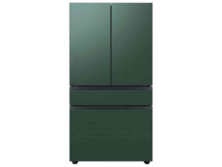 a green refrigerator freezer sitting on top of a white wall