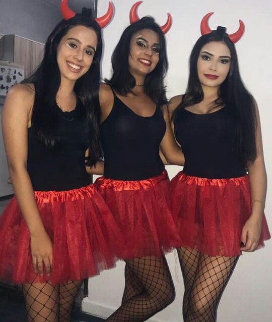 three women in devil costumes posing for the camera