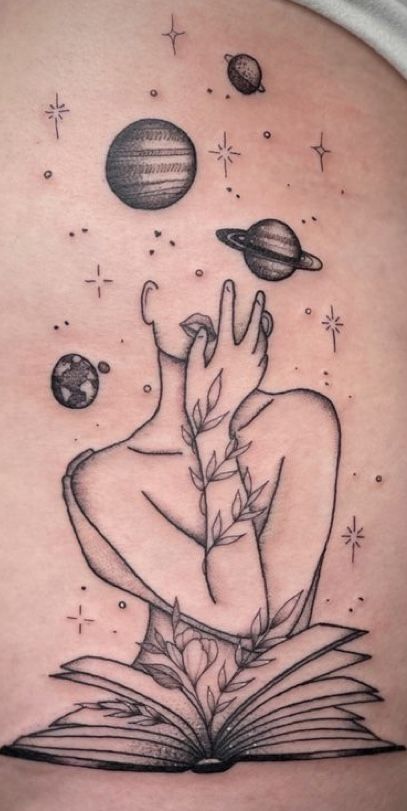 a woman's stomach with an open book and planets in the sky above her