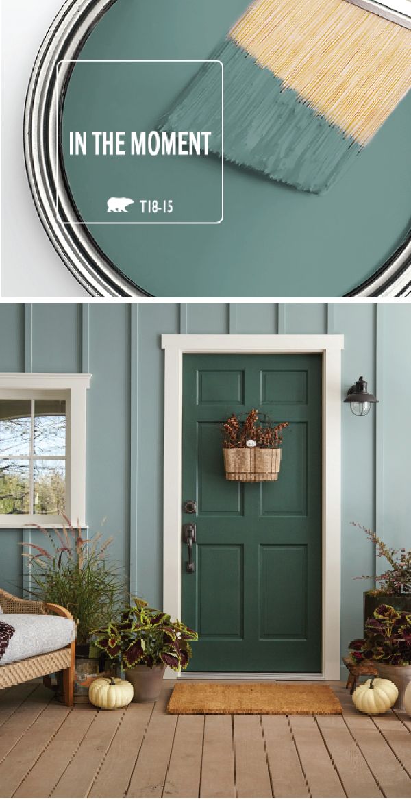 a green door with the words in the moment on it and an image of some plants