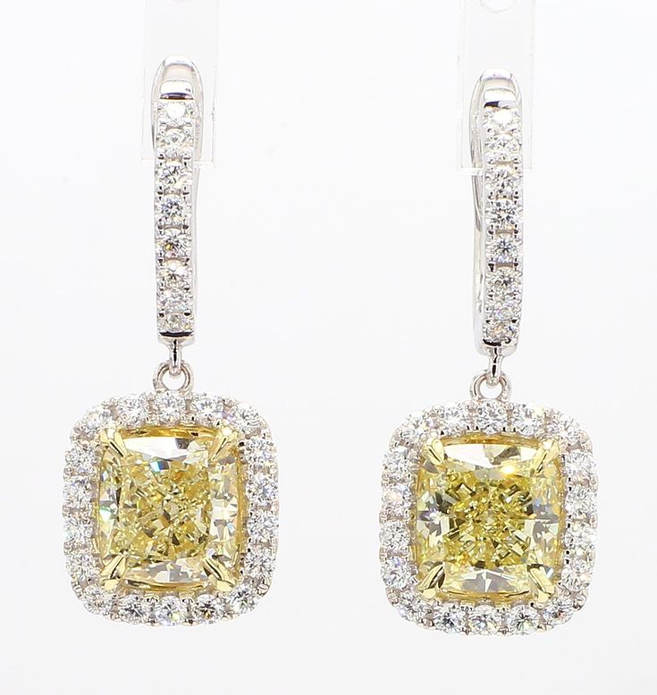 RareGemWorld's classic GIA certified diamond earrings. Mounted in a beautiful 18K Yellow and White Gold setting with natural cushion cut yellow diamonds. The yellow diamonds are surrounded by round natural white diamond melee. These earrings are guaranteed to impress and enhance your personal collection! Total Weight: 5.24cts Natural Light Yellow Cushion Cut Diamond Measurement:  7.25 x 6.90 x 4.72 mm Carat Weight: 2.17cts Clarity Grade: VS1 Natural Light Yellow Cushion Cut Diamond Measurement: 7.39 x 7.06 x 4.75 mm Carat Weight: 2.23cts Clarity Grade: VVS2 Natural Round White Diamonds 18K Yellow/White Gold All diamonds are guaranteed natural International Shipments: Please note that customers are responsible for all import duties and taxes applicable to the country of shipment Returns: Re Yellow Diamond Earrings, Yellow Cushion, Yellow Cushions, Yellow Diamonds, Natural Cushions, White Gold Set, Cushion Diamond, Cushion Cut Diamonds, Gold Drop Earrings