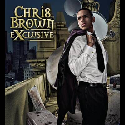 a man standing on top of a roof in front of a cityscape with the words,'chris brown exclusive '