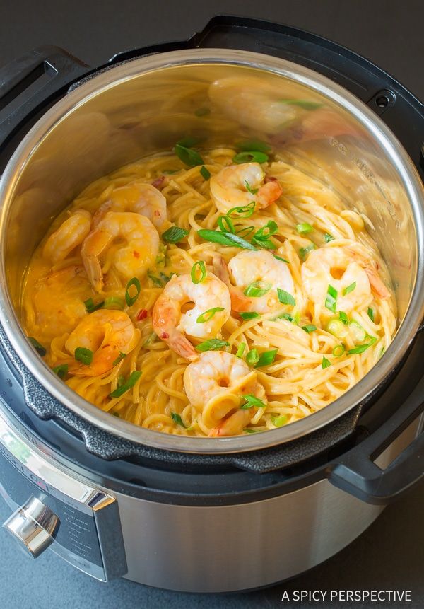 shrimp and noodle soup in an instant pot with the lid open, ready to be cooked