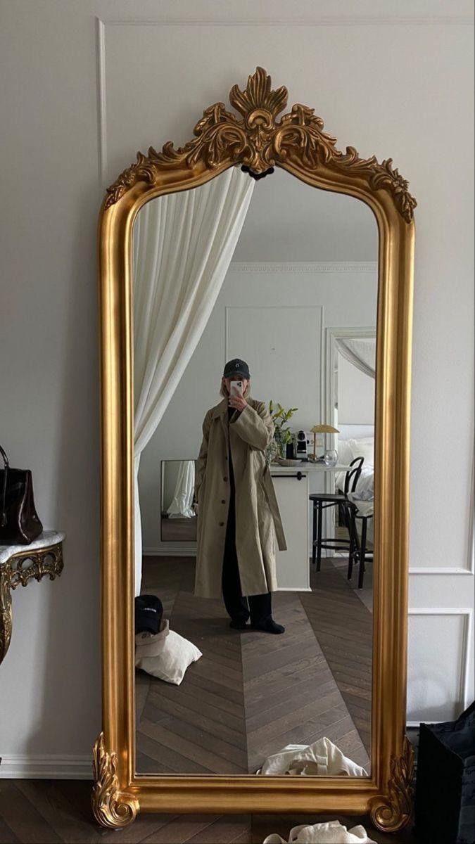 a man standing in front of a mirror taking a selfie