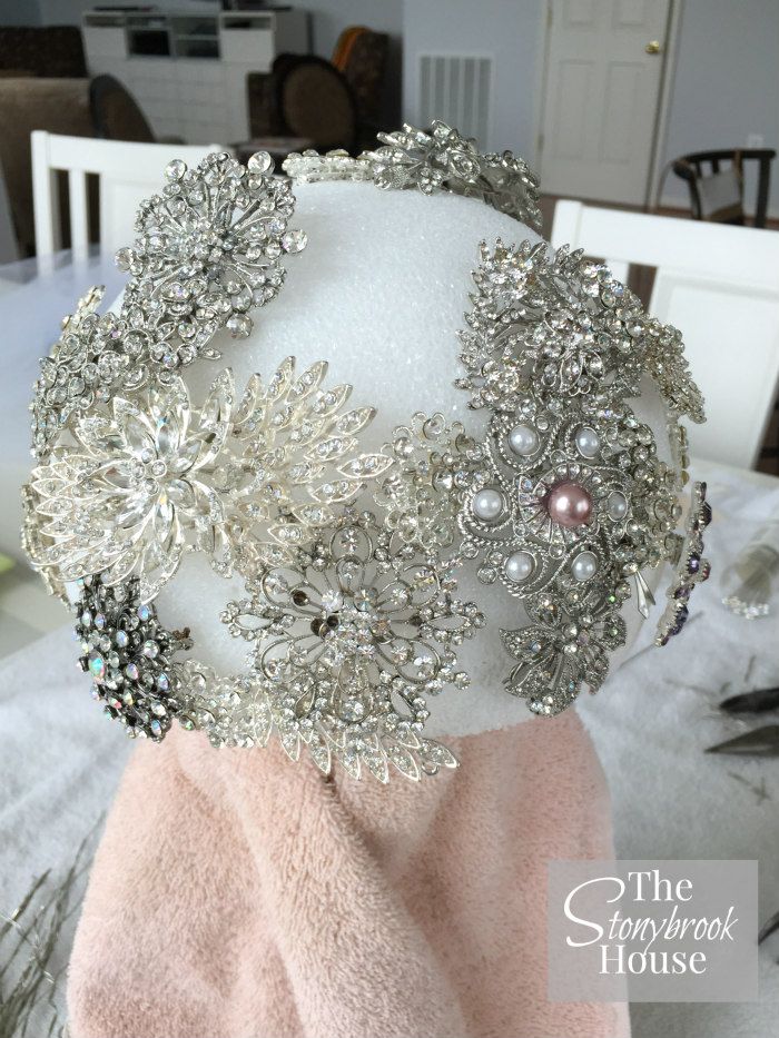 the headpiece is adorned with crystal and pearls