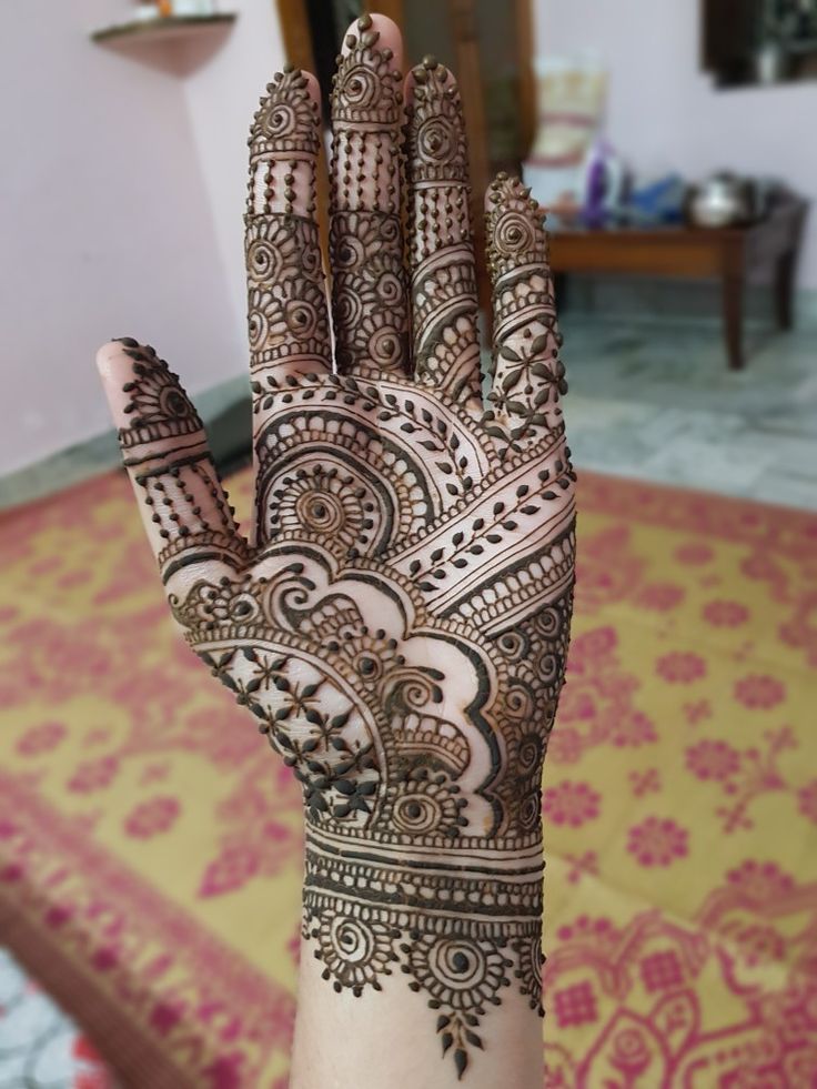 the hand is decorated with henna on it