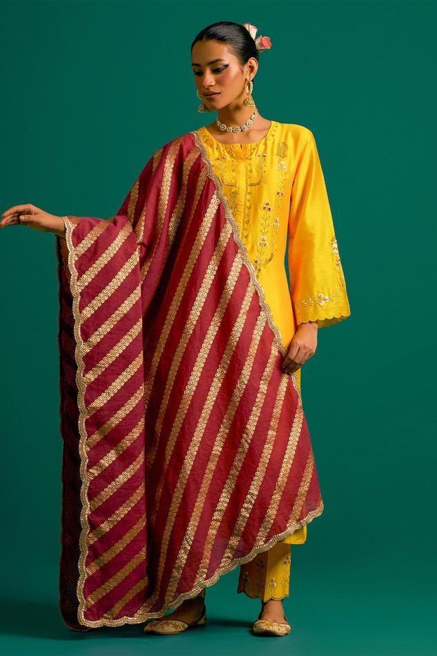 Yellow silk chanderi kurta with placed thread floral embroidery and scalloped edges. Comes with matching pant and contrast wine dupatta.
Components: 3
Pattern: Embroidered
Type Of Work: Floral,Sequin
Neckline: Round
Sleeve Type: Full
Fabric: Kurta and Pant: Silk Chanderi, Dupatta: Chanderi
Color: Yellow
Other Details: 
Model Height: 5ft 6inches wearing size S
Closure: Kurta: Front hook
Occasion: Mehendi and Haldi - Aza Fashions Yellow Kurta, Chanderi Dupatta, Kurta Pant Set, Yellow Silk, Kurta With Pants, Scalloped Edges, Set For Women, Aza Fashion, Model Height