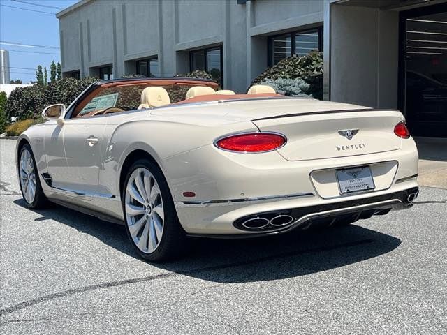 a white convertible car parked in front of a building