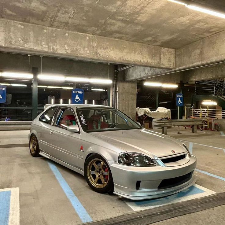 a silver car parked in a parking garage