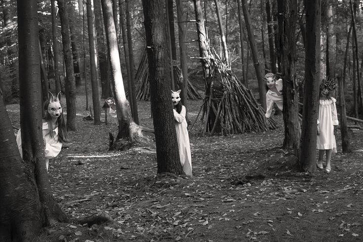 some people in costumes are walking through the woods