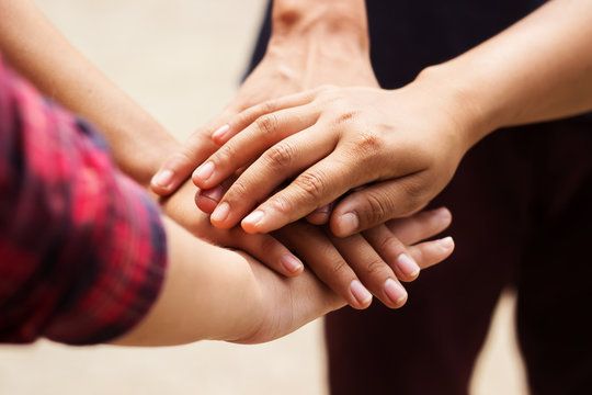 group of people holding hands together