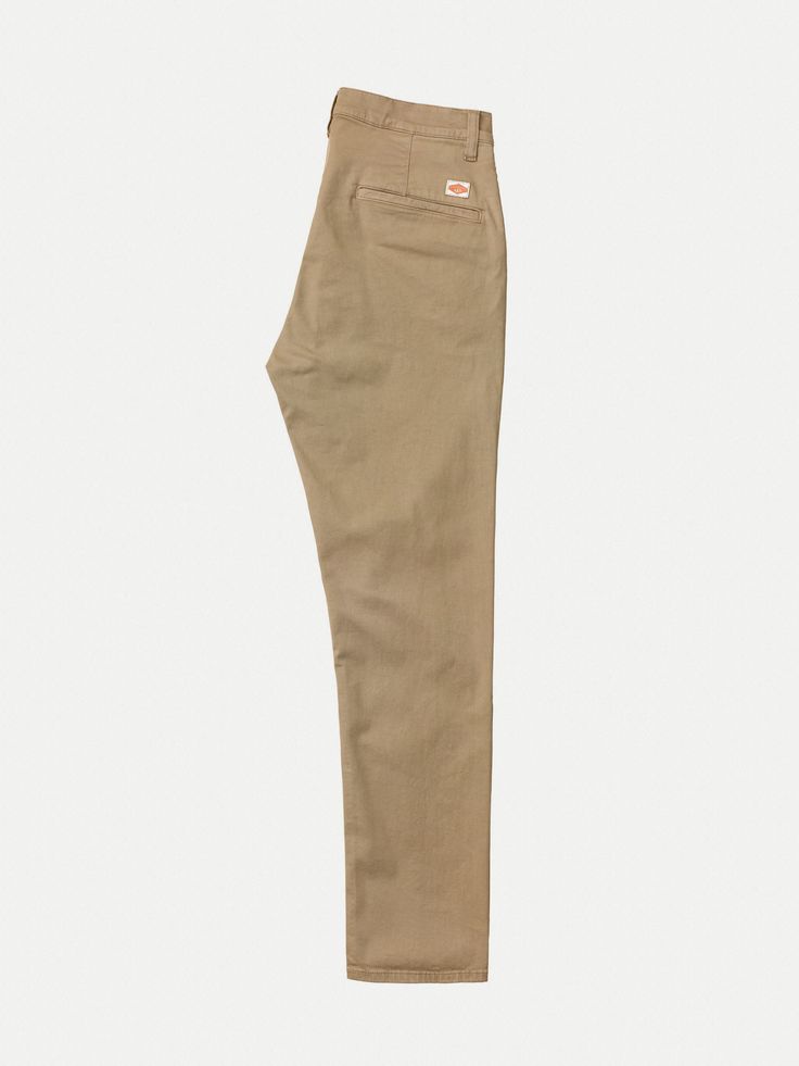 Slim fit four-pocket chino made in a clean organic comfort stretch twill. It is a contemporary classic with slanted front pockets, welt back pockets, chain stitch hems, and slim tapered fit. If you ask us, it is the perfect slim fit chino - fitted with a bit of room around the legs, making it look neat and fit very comfortably. Its sewn with heavy tone-in-tone thread with medium-short stitch length, which emphasizes its clean construction and pays homage to its workwear heritage. Solid Jeans With Welt Pockets For Work, Chino Cotton Twill Bottoms For Workwear, Relaxed Fit Work Pants With Welt Pockets, Workwear Chinos In Chino Cotton Twill, Chino Cotton Twill Chinos For Work, Standard Cut Leg Chinos For Workwear, Chino Cotton Twill Workwear Bottoms, Workwear Chinos With Standard Cut Leg, Everyday Chinos With Tapered Leg In Chino Cotton Twill