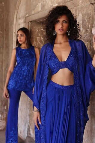 Electric blue cape featuring resham embroidery with floral motifs embellished by beads and sequins. Comes with matching inner blouse and pleated skirt. - Aza Fashions Fitted Tops With Cape Sleeves, Embellished Blue Choli, Party Blue Choli With Cape Sleeves, Blue Party Sets With Cape Sleeves, Blue Fitted Evening Choli, Evening Blue Fitted Choli, Blue Long Sleeve Embellished Choli, Beaded Cape, Blue Cape