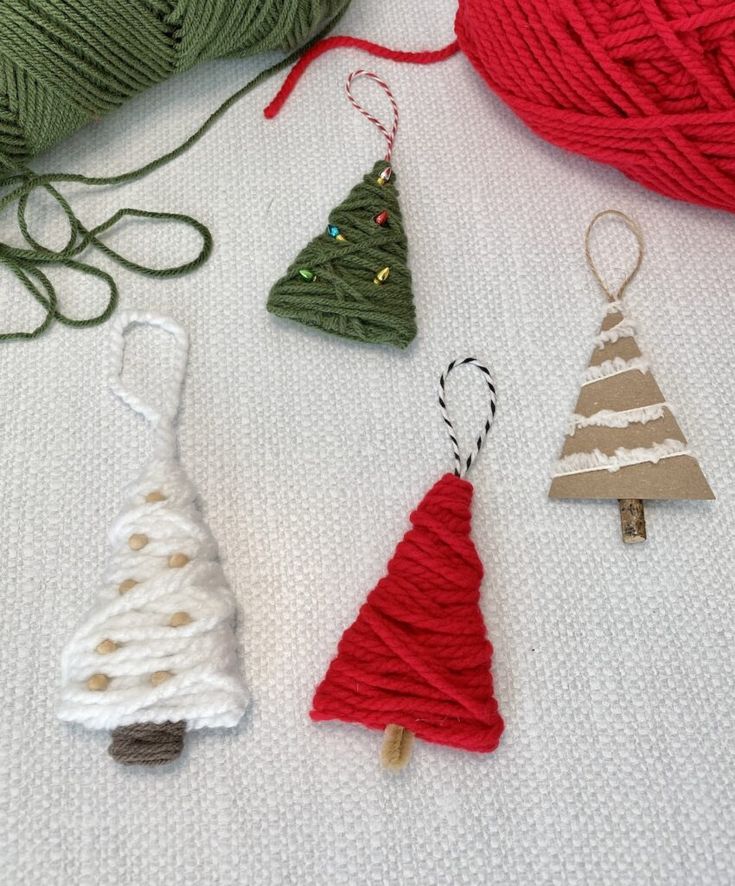 crocheted ornaments are displayed on a table with yarn and thread in the background