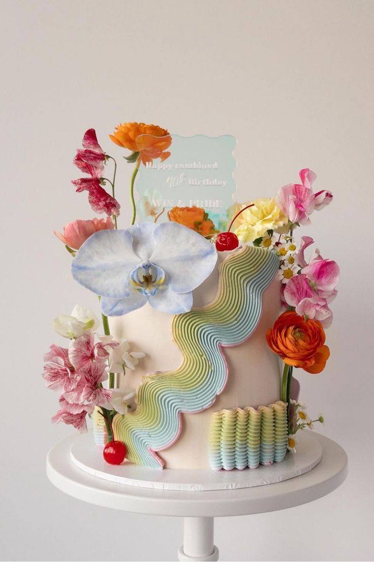 a multi - tiered cake decorated with flowers on a table