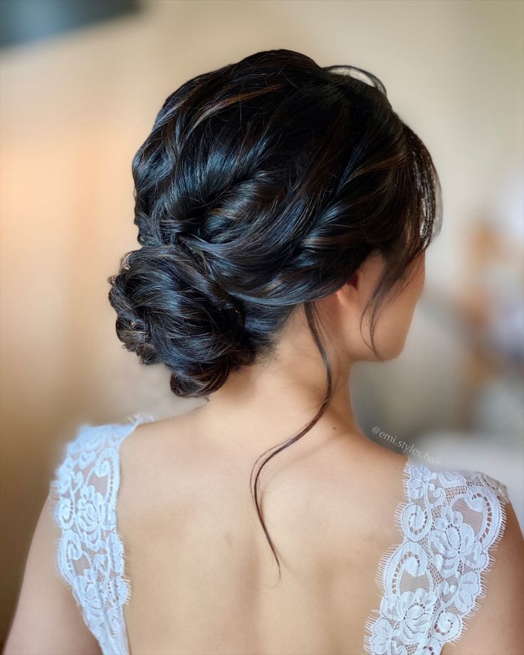 the back of a woman's head wearing a wedding dress