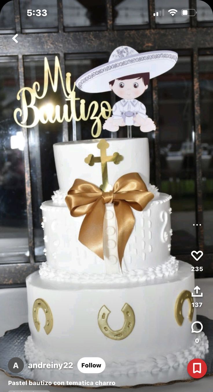 a three tiered cake with a gold bow on top and the words my boutiques above it