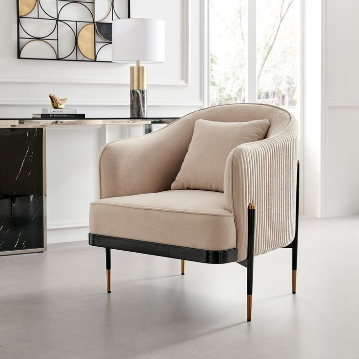 a beige chair sitting in front of a window