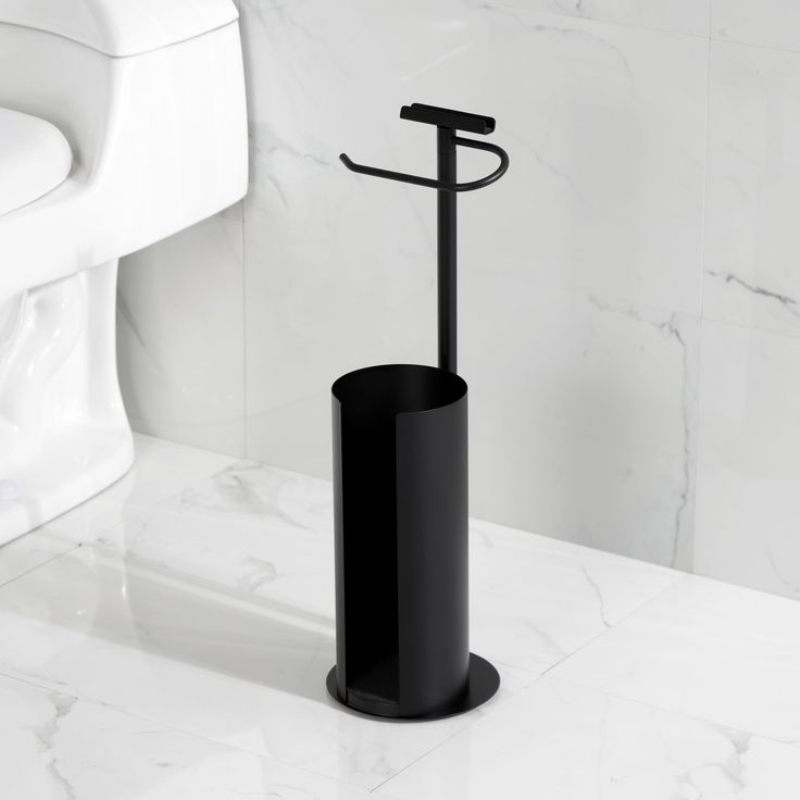 a black toilet brush holder in a bathroom