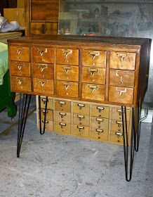 an old dresser with many drawers and hairpin legs