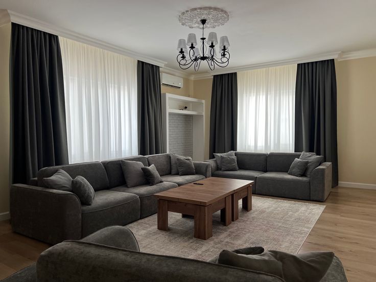 a living room filled with furniture and a chandelier