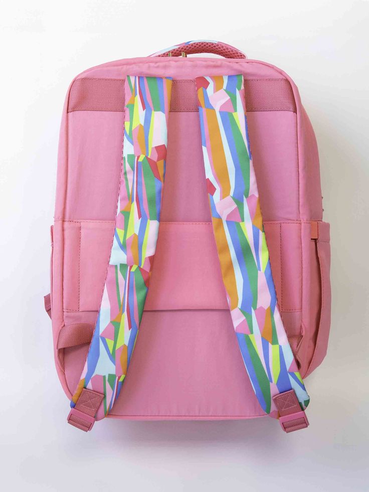 The Travel Backpack is a blend of style and practicality designed to enhance your travel experience. It features a solid color exterior adorned with vibrant patterns on the handles and straps. Its size is the perfect balance between spaciousness and convenience, making it an ideal companion for your travels! Details: 13"W x 16.5"H x 8"D Patterned handle and straps Two main large pockets Two side pockets One front pocket Luggage sleeve with zipper pocket Polyester material Gold hardware Pink Backpack, Travel Backpack, Gold Hardware, Travel Experience, Zipper Pocket, Zipper, Solid Color, Backpacks, Pink