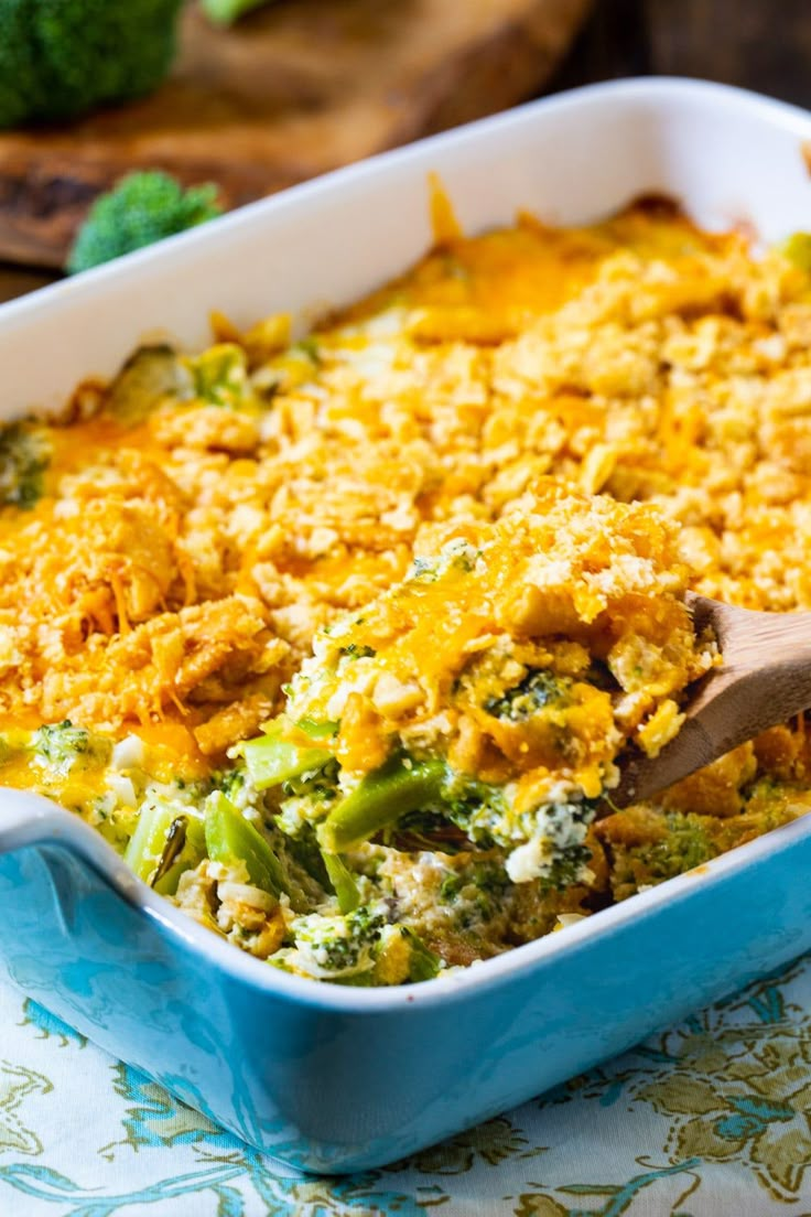 a casserole dish with broccoli and cheese in it on a table