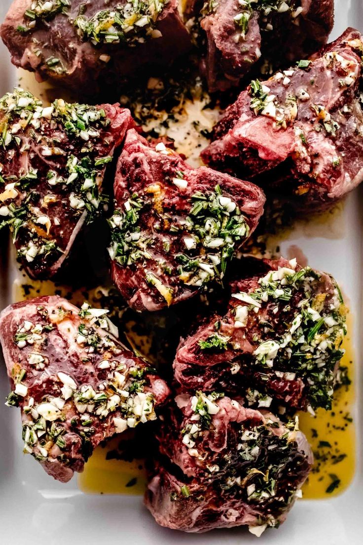 raw meat with herbs and seasoning on a white plate