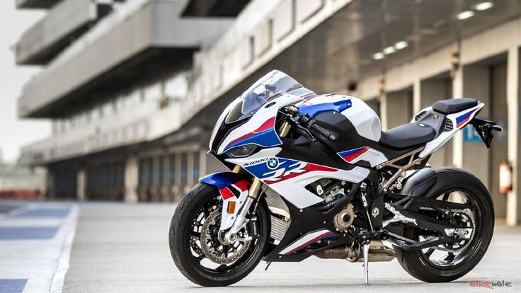 a white and blue motorcycle parked in front of a building