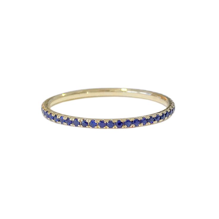 "This finely handcrafted ring is made completely of 14K solid gold and micro pavé set with genuine AAA quality round brilliant cut natural real Blue Sapphire gemstones. Perfect for stacking. ♦ Band Width: approximately 1.3mm ♦ Metal Finish: High Shine Polish ♦ This design is available in Rose, White and Yellow 14K Gold; also in 14K White Gold with Black Rhodium Plated Finish ♦ Our inventory is limited on Etsy. You can find more quantities and unique designs by vising our website: www.nanabijouje Yellow Gold Eternity Band With Pave Setting, Yellow Gold Sapphire Ring With Halo, Yellow Gold Eternity Band With Pave Setting For Promise, 14k Gold Sapphire Ring With Halo, Yellow Gold Pave Setting Eternity Band For Promise, Gold Sapphire Eternity Band With Prong Setting, 14k Gold Hoop Rings With Vvs Clarity, Sapphire Eternity Band With Vvs Clarity, 14k Yellow Gold Sapphire Ring With Halo