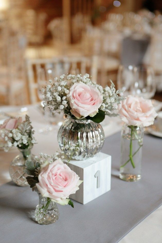 three vases with flowers are sitting on a table at a wedding reception, ready to be used as centerpieces