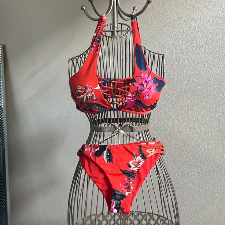 Size Medium Bottoms Are Reversible To Solid Red Hips Have Crisscross Cutout Sides Never Worn With Liner Intact In Bottoms Top Has Brass Toned Beading. Slip On Top With Bra Like Straps Perfect For The Summer Months Approaching! Red Tropical Swimwear For Poolside, Red Tankini With Tie-side Bottom, Red Beachwear Tankini With Tie-side Bottom, Red Tie-side Bottom Tankini For Summer, Red Tankini With Tie-side Bottom For Swimming, Red Halter Neck Swimwear For Beach, Red Halter Neck Swimwear For Beach Party, Red Halter Neck Beach Swimwear, Red Halter Neck Tankini For Vacation