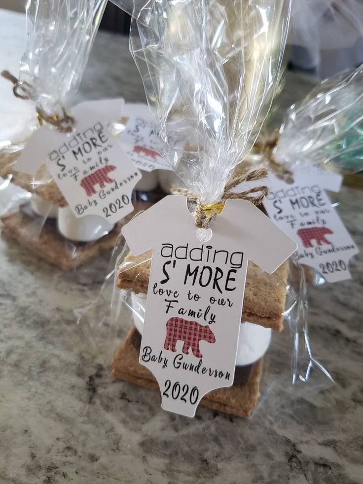 some cookies are wrapped in plastic and sitting on a counter top with tags attached to them