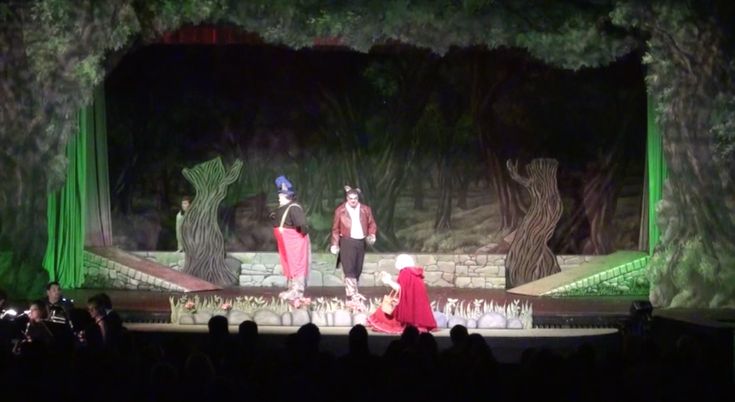 two people are performing on stage in front of an audience