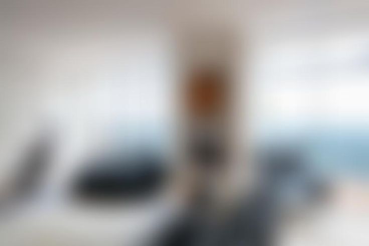 blurry image of an object in front of a white wall with blue and gray colors