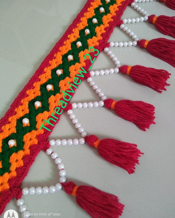 the tassels are decorated with pearls and beads on it's side,