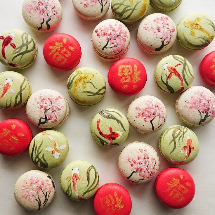 some red and green balls with designs on them sitting next to each other in front of a white background