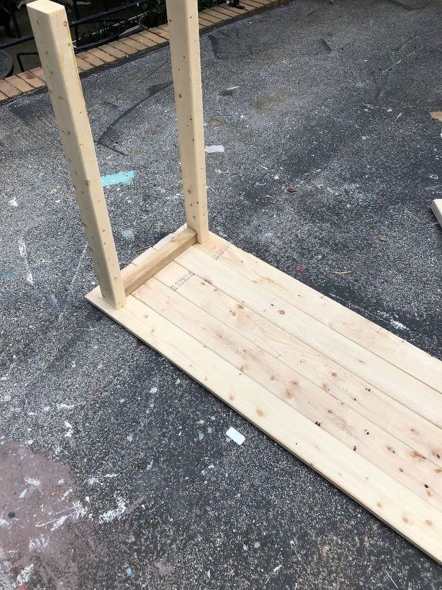 a wooden bench sitting on top of a sidewalk